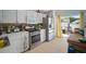 Bright kitchen with stainless steel appliances, white cabinets, and sliding glass doors to the backyard at 7534 Oxford Garden Cir, Apollo Beach, FL 33572