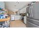 Open kitchen with white cabinets, stainless steel appliances and eat-in bar at 7534 Oxford Garden Cir, Apollo Beach, FL 33572