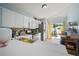 Bright kitchen with stainless steel appliances, white cabinets, and sliding glass doors to the backyard at 7534 Oxford Garden Cir, Apollo Beach, FL 33572