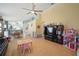 View of an open concept living room with tile flooring, neutral walls, and living room decor and furniture at 7534 Oxford Garden Cir, Apollo Beach, FL 33572