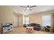 Open living room showcases tile floors, neutral walls, a ceiling fan, and a variety of furniture at 7534 Oxford Garden Cir, Apollo Beach, FL 33572