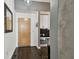 Apartment entryway with dark floors, built in shelving desk area, and modern door at 777 N Ashley Dr # 2510, Tampa, FL 33602