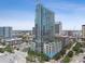 Modern high-rise condo with glass windows, pool, and city views on a bright and sunny day at 777 N Ashley Dr # 2510, Tampa, FL 33602