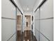 Hallway with closet space and an open door, with view into the modern bathroom with stylish black and white floor at 777 N Ashley Dr # 2510, Tampa, FL 33602