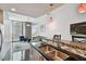 Open floor plan showcasing the kitchen island with stainless steel sink and adjacent living area at 777 N Ashley Dr # 2510, Tampa, FL 33602