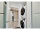 Laundry area near the main bathroom featuring stacked washer and dryer at 777 N Ashley Dr # 2510, Tampa, FL 33602