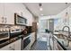 Well lit kitchen and living room space with stainless steel appliances and cityscape view at 777 N Ashley Dr # 2510, Tampa, FL 33602