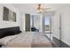 Bedroom featuring floor-to-ceiling windows with city views, a comfortable bed, and a serene ambiance at 777 N Ashley Dr # 2510, Tampa, FL 33602