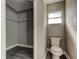 Half bathroom with a toilet, small window, and vinyl flooring at 8330 Lafitte Dr, Hudson, FL 34667