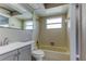 Bathroom with a tub and shower combo featuring neutral walls and white accents at 8330 Lafitte Dr, Hudson, FL 34667