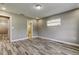 This bedroom offers wood-look flooring, a neutral color scheme, and a window at 8330 Lafitte Dr, Hudson, FL 34667