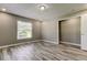 Bedroom with wood look floors, a large window, and an open closet at 8330 Lafitte Dr, Hudson, FL 34667