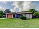 Single-story home featuring an attached garage and a well-maintained lawn at 8330 Lafitte Dr, Hudson, FL 34667