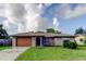 Charming single-story home featuring an attached garage, well-manicured lawn, and simple landscaping at 8330 Lafitte Dr, Hudson, FL 34667