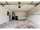 A spacious, empty garage interior with laundry hookups, a utility sink, and plenty of room for storage at 8330 Lafitte Dr, Hudson, FL 34667