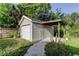 Exterior view of a detached one-car garage with siding and covered parking at 8330 Lafitte Dr, Hudson, FL 34667