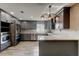 Modern kitchen with gray cabinets, stainless appliances, and a spacious countertop at 8330 Lafitte Dr, Hudson, FL 34667