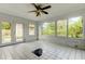 This lanai features tiled flooring and a view of the backyard and landscaping at 8330 Lafitte Dr, Hudson, FL 34667