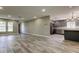 Open-concept living room with wood-look tile and seamless access to kitchen at 8330 Lafitte Dr, Hudson, FL 34667