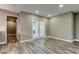 Living room with wood-look flooring, recessed lighting, and white french doors at 8330 Lafitte Dr, Hudson, FL 34667