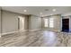 This living room offers a neutral color scheme and updated wood-look flooring at 8330 Lafitte Dr, Hudson, FL 34667