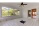 Bright sunroom with white tile floors, large windows, and ceiling fan at 8330 Lafitte Dr, Hudson, FL 34667