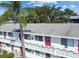 Close up of a white two-story building with red doors and holiday themed outdoor decor at 8425 112Th St # 203, Seminole, FL 33772