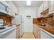 Compact kitchen with white appliances, tile floor, and updated countertops at 8425 112Th St # 203, Seminole, FL 33772