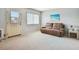 Cozy living room with plush carpeting, neutral walls, and comfortable seating at 8425 112Th St # 203, Seminole, FL 33772