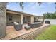 This backyard features a patio with a hot tub, grill, and comfortable seating area at 8518 Tidal Breeze Dr, Riverview, FL 33569