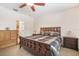 Spacious bedroom with carpet flooring featuring a ceiling fan and a window for natural light at 8518 Tidal Breeze Dr, Riverview, FL 33569