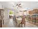 Bright dining area with bar seating, sliding glass doors to the patio, and open to the kitchen at 8518 Tidal Breeze Dr, Riverview, FL 33569