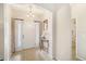 Welcoming entryway with neutral tones, tile flooring, decorative mirror, and elegant lighting at 8518 Tidal Breeze Dr, Riverview, FL 33569
