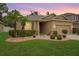 Charming home featuring a well-manicured lawn and landscaped garden beds with palm trees at 8518 Tidal Breeze Dr, Riverview, FL 33569