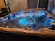 Relaxing hot tub with water features and soothing blue lighting at 8518 Tidal Breeze Dr, Riverview, FL 33569