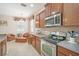 Well-lit kitchen featuring stainless steel appliances and plenty of wooden cabinet storage at 8518 Tidal Breeze Dr, Riverview, FL 33569