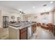 Open-concept kitchen featuring a breakfast bar and view into the dining and living areas at 8518 Tidal Breeze Dr, Riverview, FL 33569