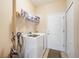 This laundry room features a washer and dryer with upper shelving at 8518 Tidal Breeze Dr, Riverview, FL 33569