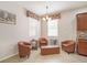 Cozy sitting area with tile flooring and leather chairs, perfect for relaxation and reading at 8518 Tidal Breeze Dr, Riverview, FL 33569