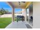 Open back patio with a built-in grill, plenty of space for outdoor seating, and lush green lawn at 8747 Flourish Dr, Land O Lakes, FL 34637
