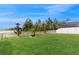 Expansive backyard with lush green lawn, partial fence, and serene lake view at 8747 Flourish Dr, Land O Lakes, FL 34637
