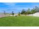 Expansive backyard with lush green grass, a white fence, and views of the surrounding landscape at 8747 Flourish Dr, Land O Lakes, FL 34637