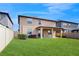 Spacious backyard with covered patio and a lush lawn at 8747 Flourish Dr, Land O Lakes, FL 34637