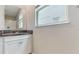 Well-lit bathroom features a granite countertop, white cabinetry, and a window allowing ample natural light at 8747 Flourish Dr, Land O Lakes, FL 34637