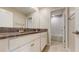 Well-lit bathroom with double sinks, granite countertops, and a separate toilet room at 8747 Flourish Dr, Land O Lakes, FL 34637