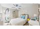 Inviting bedroom with a cozy hammock chair, stylish decor, and a dedicated workspace at 8747 Flourish Dr, Land O Lakes, FL 34637