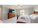 Bright bedroom featuring plush carpeting, a ceiling fan, and a scenic view from the window at 8747 Flourish Dr, Land O Lakes, FL 34637