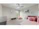 Charming bedroom with a plush pink bed, soft lighting, and colorful decor accents at 8747 Flourish Dr, Land O Lakes, FL 34637