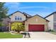Beautiful two-story home with a red garage door, a meticulously maintained lawn, and an inviting, landscaped entrance at 8747 Flourish Dr, Land O Lakes, FL 34637
