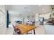Open floor plan features a kitchen with stainless appliances and breakfast bar flowing into the living area with staircase access at 8747 Flourish Dr, Land O Lakes, FL 34637